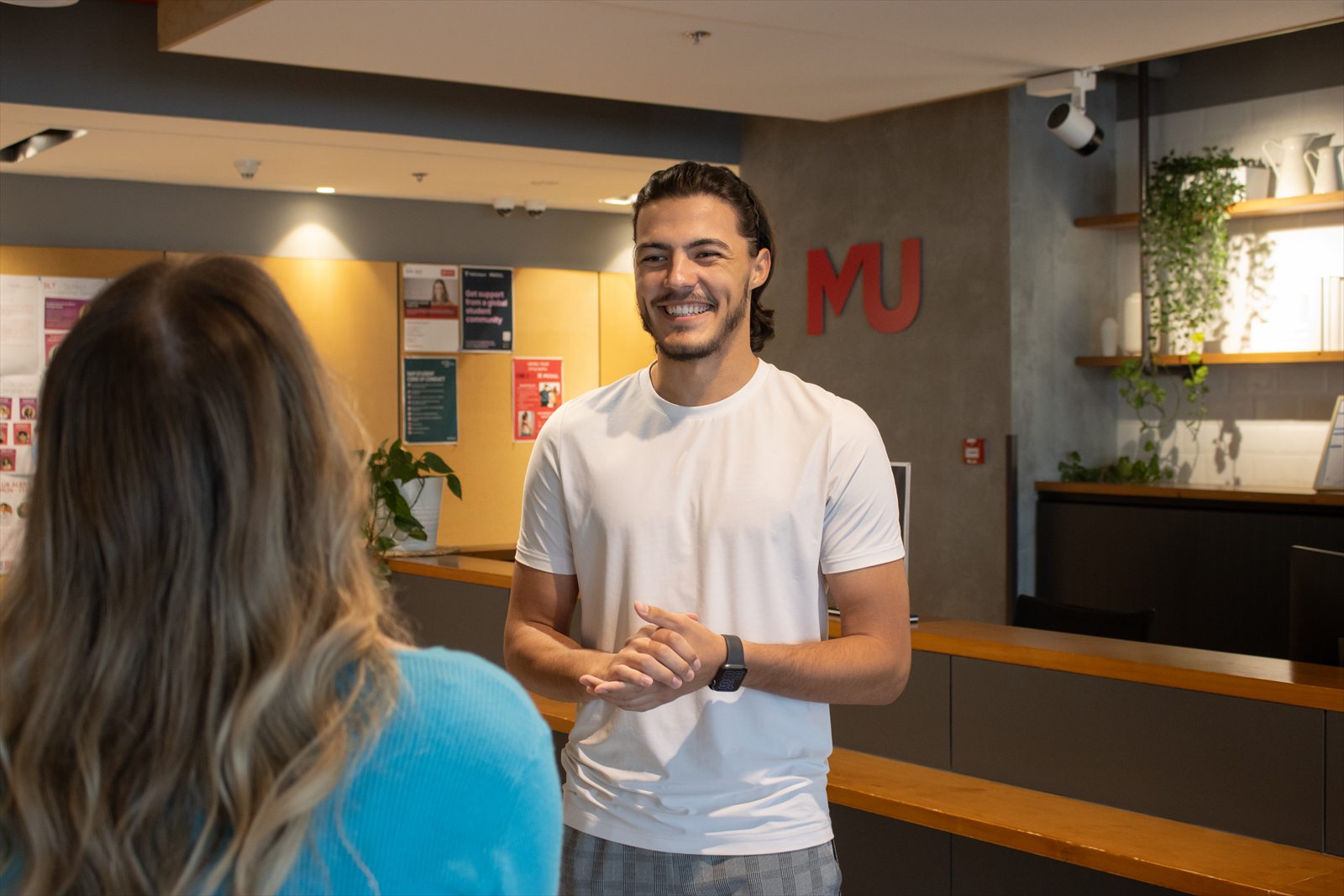 A Murdoch University Dubai team member helping a student